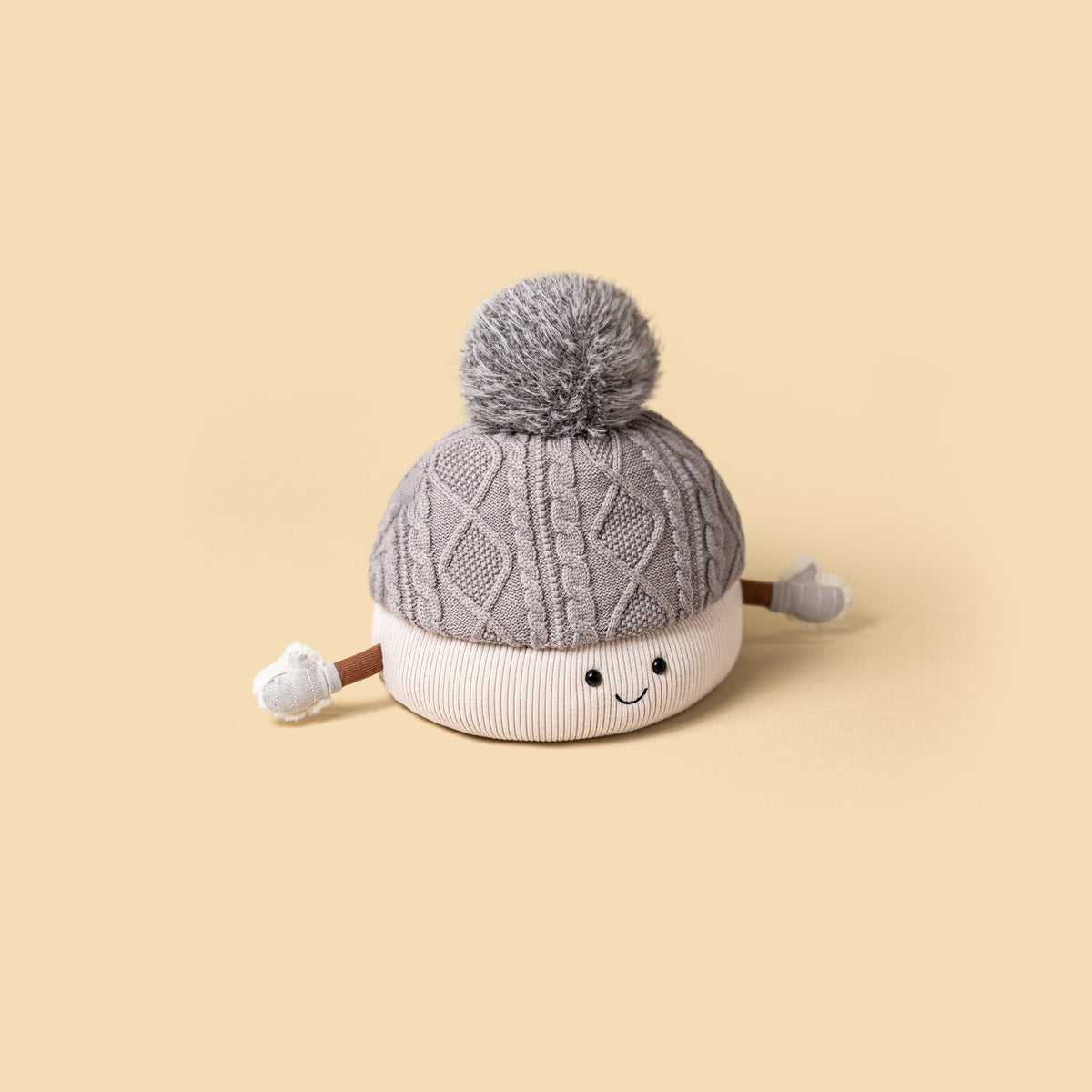 Kuscheltier-Mütze Pomilly mit grauer Strickmütze, Bommel und freundlichem Gesicht